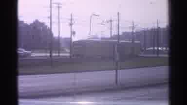 Ohio USA (1965): Yellow Train Moving Down The Tracks Through A Small Town