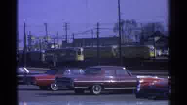 Ohio USA (1965): Watching A Public Transit Trolley Or Light Rail From Parking Lot