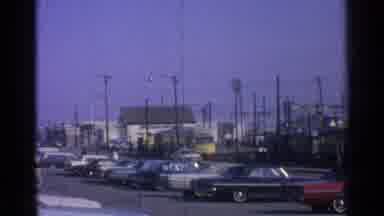 Ohio USA (1965): A Passenger Train Rounds A Curve In The Track As Cars And