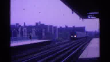 Ohio USA (1965): Train Rolling Down The Tracks About To Pick Up A Bunch Of People