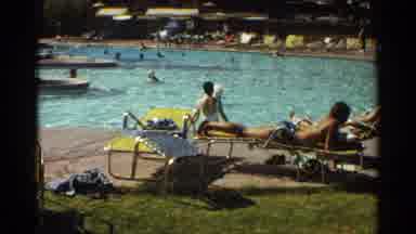 Scottsdale Arizona (1968): A Woman Swims In Pool Surrounded By A Lot Of People In