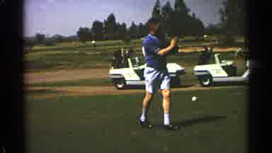 Scottsdale Arizona (1968): Man In Blue Shirt Swings Golf Club With Two Golf Carts