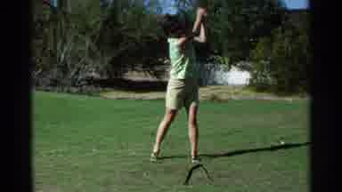 Scottsdale Arizona (1968): Woman In Green Practices Her Golf Swing Then Smiles For