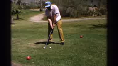 Scottsdale Arizona (1968): Man Hitting A Golf Ball Between Two Red Balls Near The