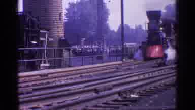 Chicago Illinois (1976): Old Train Billows Smoke As It Slowly Enters A Station