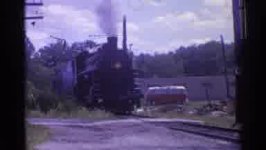 Chicago Illinois (1976): A Black Train Approaches Down The Track Puffing Gray