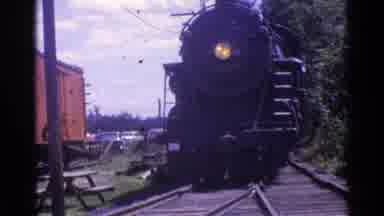 Chicago Illinois (1976): A Locomotive Train Rides By Trees Picnic Table And Train