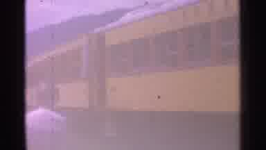 Chicago Illinois (1976): Woman Wearing White Dress Walks Past Yellow Train Cars On