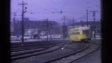 Chicago Illinois (1976): Yellow Train Sails Down The Railroad Tracks And Slows As