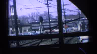 Chicago Illinois (1976): A Train Travels Along The Tracks Passing Signs And