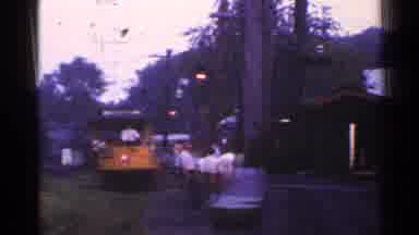 Connecticut USA (1953): Group Of People Prepare To Board Yellow Trolley Car On A