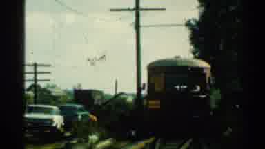 Connecticut USA (1953): A Red Train Passing On The Tracks Of A City
