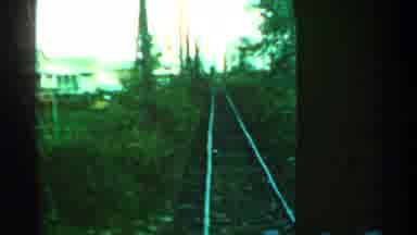 Connecticut USA (1953): Slow Moving Train Passing By A House With Some Trees In