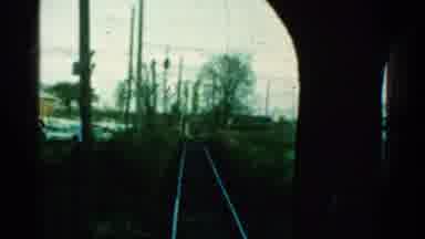 Connecticut USA (1953): Train Moving Slowly Along The Tracks Against A Junkyard