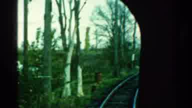 Connecticut USA (1953): A Train Rides A Track That Passes Barren Trees And Goes In