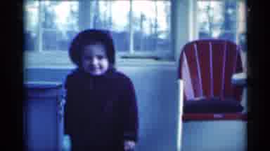 Michigan USA (1939): A Little Girls Plays In Her Dress And Bonnet In The House