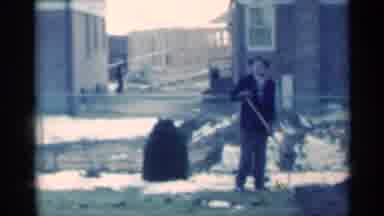 Michigan USA (1939): Child Talking To Man While He Digs With Shovel In A City