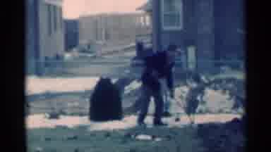 Michigan USA (1939): A Man Standing In A Yard Attempting To Shovel Some Dirt