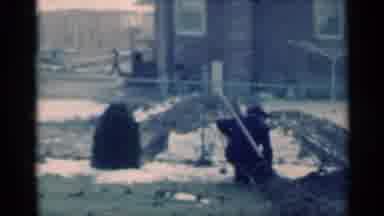 Michigan USA (1939): Man Hammers A Stake Into The Ground In His Fenced In Backyard