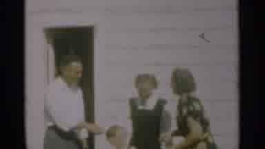 New Orleans Lousiana (1949): Woman Wearing Black Dress Shakes Hand Of Man Wearing