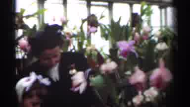 New Orleans Lousiana (1949): Woman Smiling With A Child As They Look At Flowers