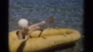 New Orleans Lousiana (1949): Girl Wearing Blue Swimwear Paddles Yellow Raft On A