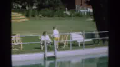 Santa Cruz California (1949): Mother And Son Sitting Poolside On A Summer Day; Son