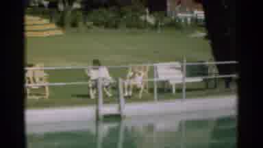 Santa Cruz California (1949): Woman And Child Sitting Outdoors By A Body Of Water