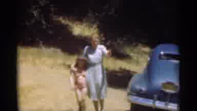 Santa Cruz California (1949): Older Women Walks Outdoors With Younger Child