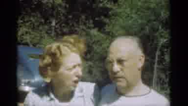 Santa Cruz California (1949): Couple Standing Near Blue Car On A Bright Sunny Day