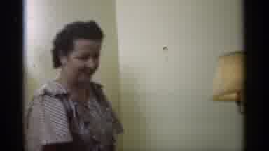 Santa Cruz California (1949): Older Woman In House By Lamp Smiling And Laughing