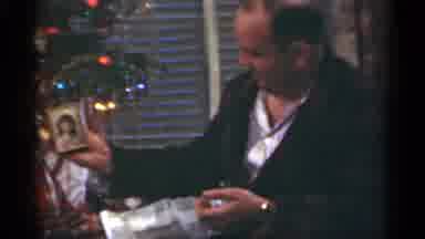 Santa Cruz California (1949): Man Sitting Next To Christmas Tree Unwraps Small