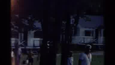 New York USA (1954): A Man Wearing A Sailor Cap Walks Across A Lawn In Front Of