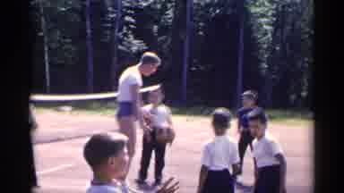 New York USA (1954): Instructor In Shorts With Basketball Facing Several Children