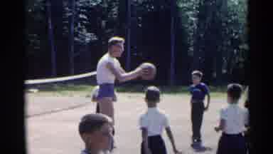 New York USA (1954): A Tall Volleyball Player Or Coach Teaches The Kids How To