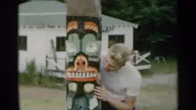 New York USA (1954): Boy Holding On To A Statue Sticking His Tongue Out And He And
