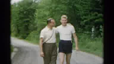New York USA (1954): Close Family Walking With Man Kissing Boy Dressed In White