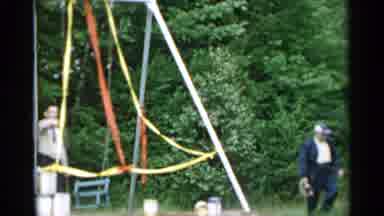 New York USA (1954): People Decorates The Swing Set With Streamers As Others