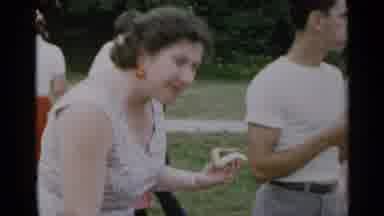 New York USA (1954): Group Of People Outside Eating Hot Dogs And Cooking On