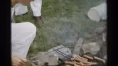 New York USA (1954): A Man Placing Hot dogs On A Little Grill And Standing Around