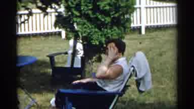 New York USA (1954): A Woman Smoothed Her Hair While Sitting In A Lawn Chair; Two