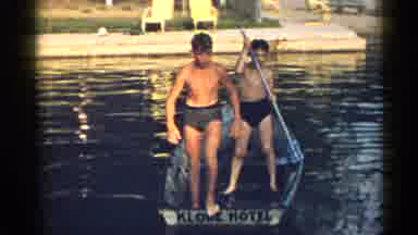New York USA (1954): Young Shirtless Boys Paddling On A Boat Dive Into The Water