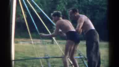New York USA (1954): Some Grown Men Swinging Around Together On A Swing As If They