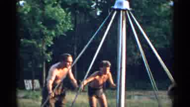 New York USA (1954): Shirtless Men And Teenage Boys On A Big Circle Swing In The