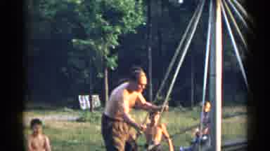 New York USA (1954): Adult And Kids Swinging On A Homemade Swing With Other Kids