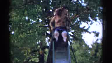 New York USA (1954): Two Older Men Having Fun Sliding Down A Metal Slide Together