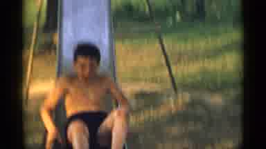 New York USA (1954): Boy Slides Down Slide Then Adjusts Jeans