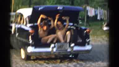 New York USA (1954): Two Boys Waving At Camera Sitting In Trunk Of Moving Car