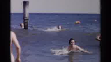 New York USA (1954): People Swimming And Talking Near Shore From Ocean