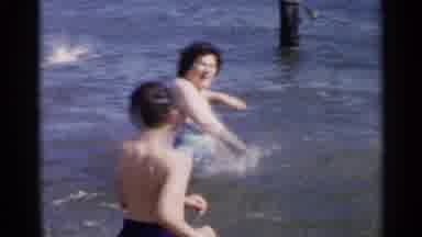 New York USA (1954): Woman Entering The Sea And Throwing Water To A Little Boy